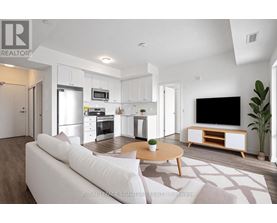 A modern living room with a white sofa, wooden coffee table, and a flat-screen TV.