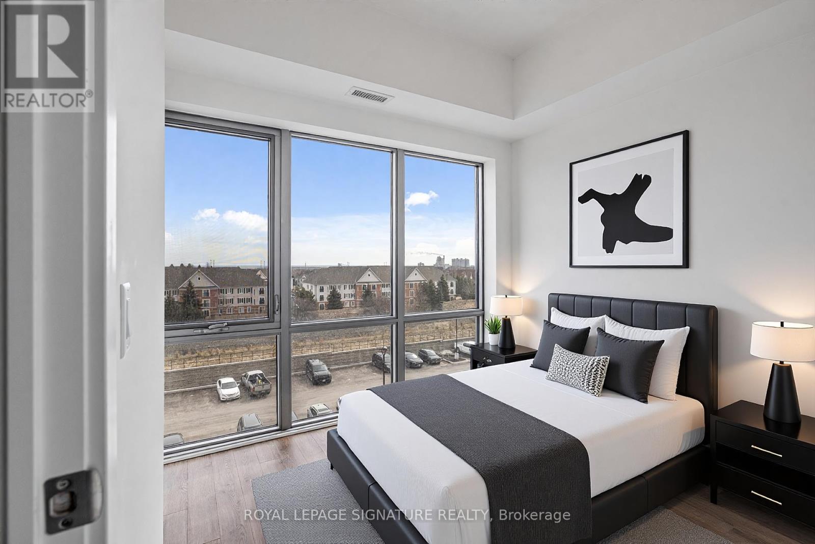 A bedroom with a large bed and a view of the city.