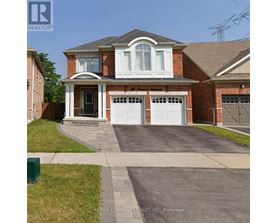 A house with a brick facade and a white garage door.