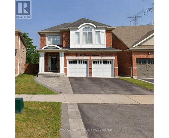 A house with a brick facade and a white garage door.