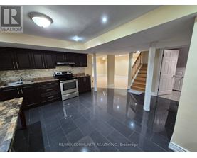 A kitchen with black cabinets and a stone countertop.