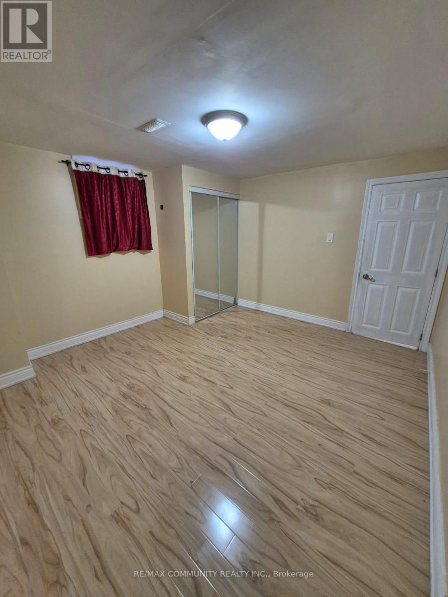 A room with a wooden floor and a white door.