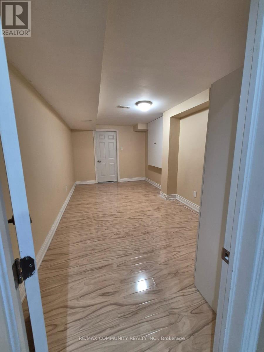 A hallway with wood flooring and white doors.