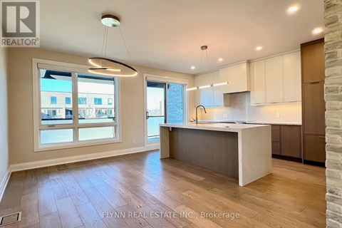 A well-lit kitchen with a dining table and chairs.