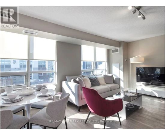 A living room with a red chair and a white couch.