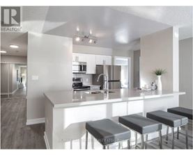 A modern kitchen with a bar stool in front of the island.