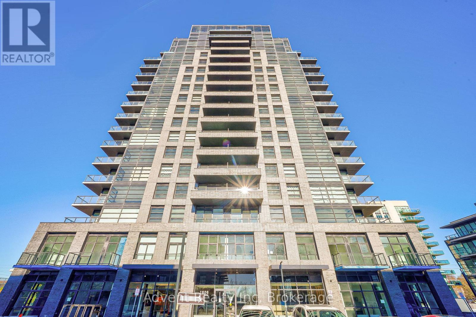 A tall building with a glass facade and a sign that reads "REALTOR".