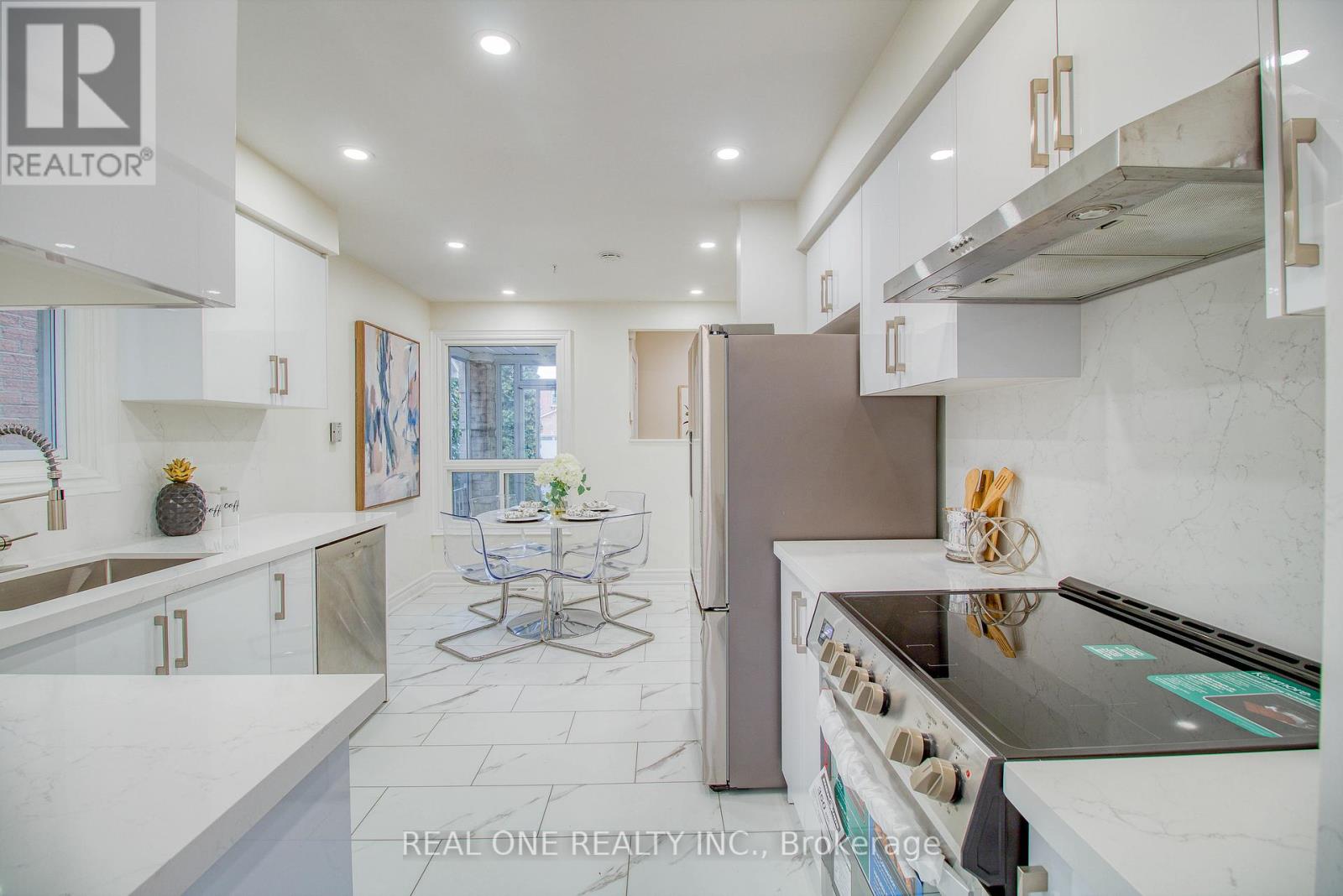 A modern kitchen with a dining table and a refrigerator.