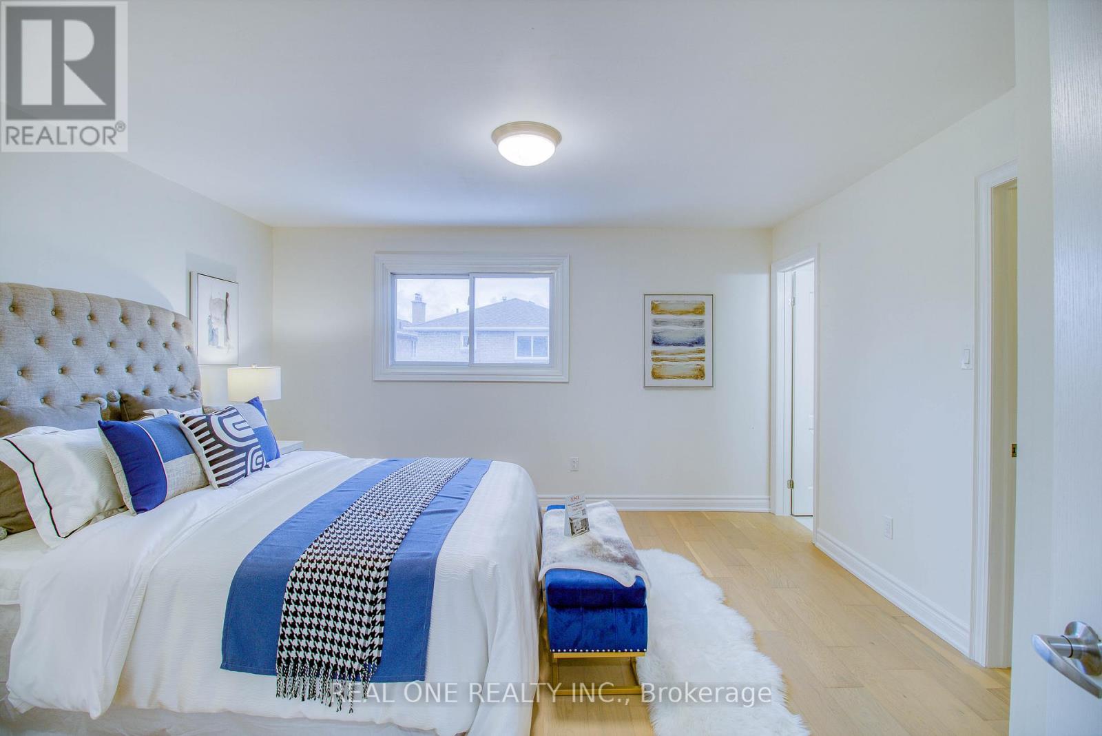 A bedroom with a bed and a window.