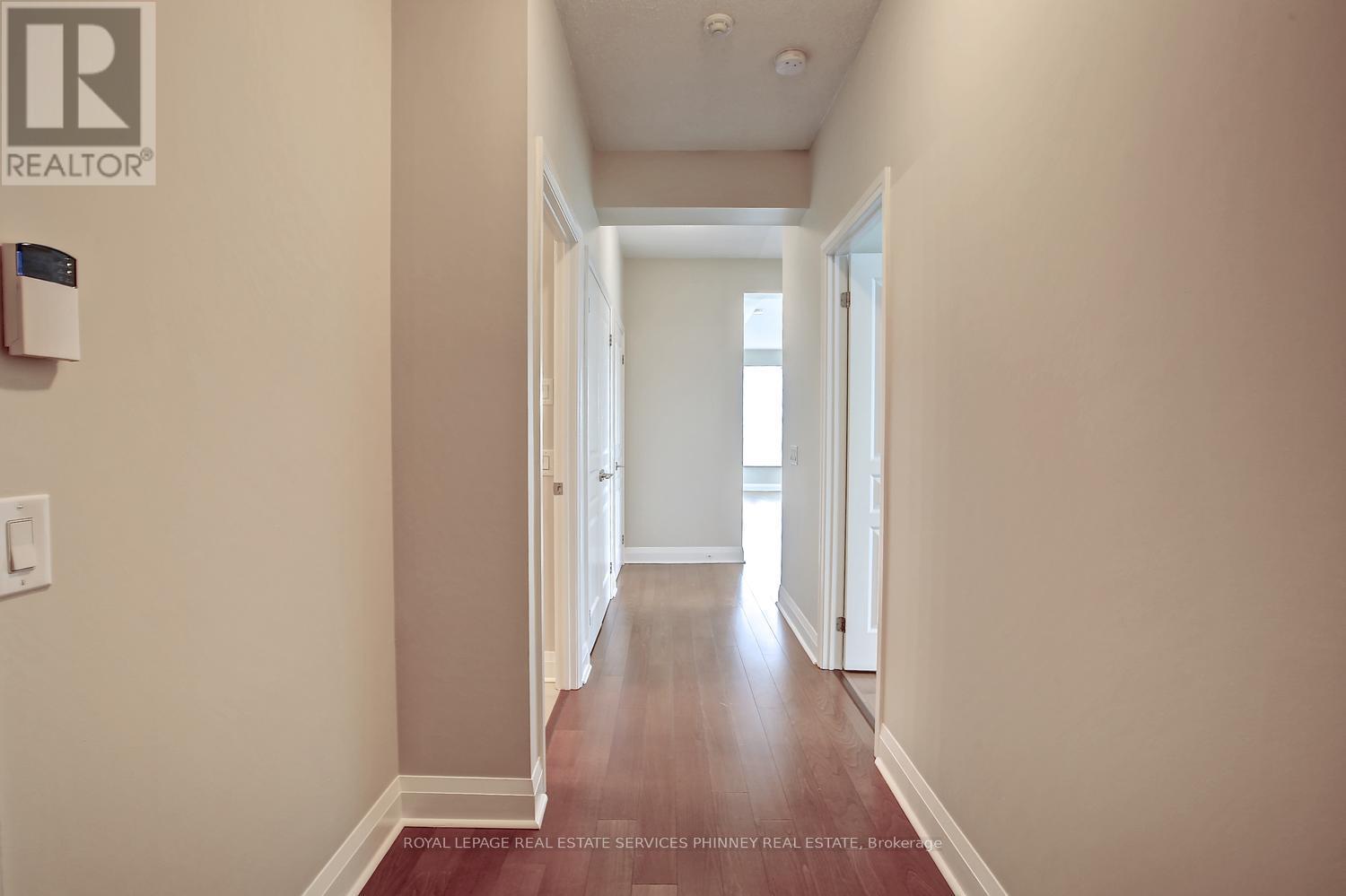 A hallway with a Realty sign on the wall.