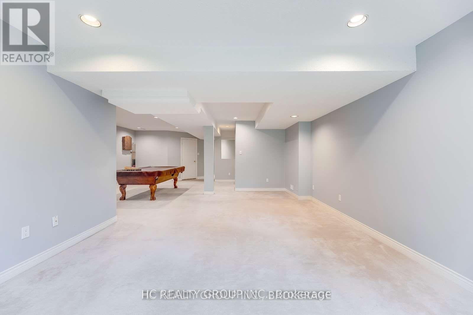 A spacious room with a pool table and a door in the background.