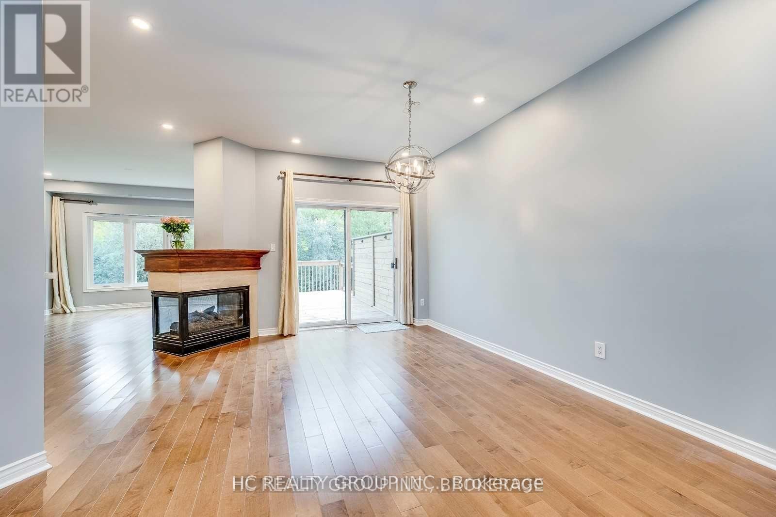 A spacious room with a fireplace and sliding glass doors.