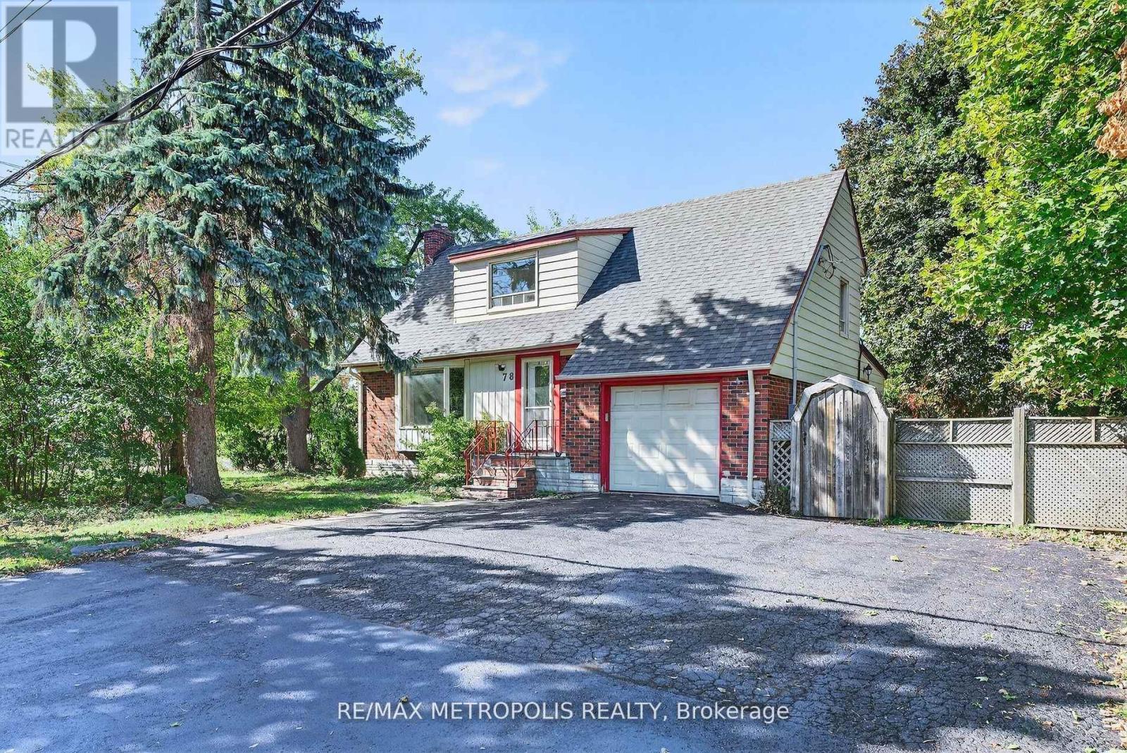 A house with a red garage door is for sale in Brokerage.