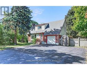 A house with a red garage door is for sale in Brokerage.