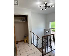 A room with a white ceiling and a white wall with a window.