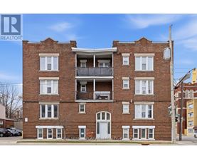 A red brick building with a balcony on the second floor.