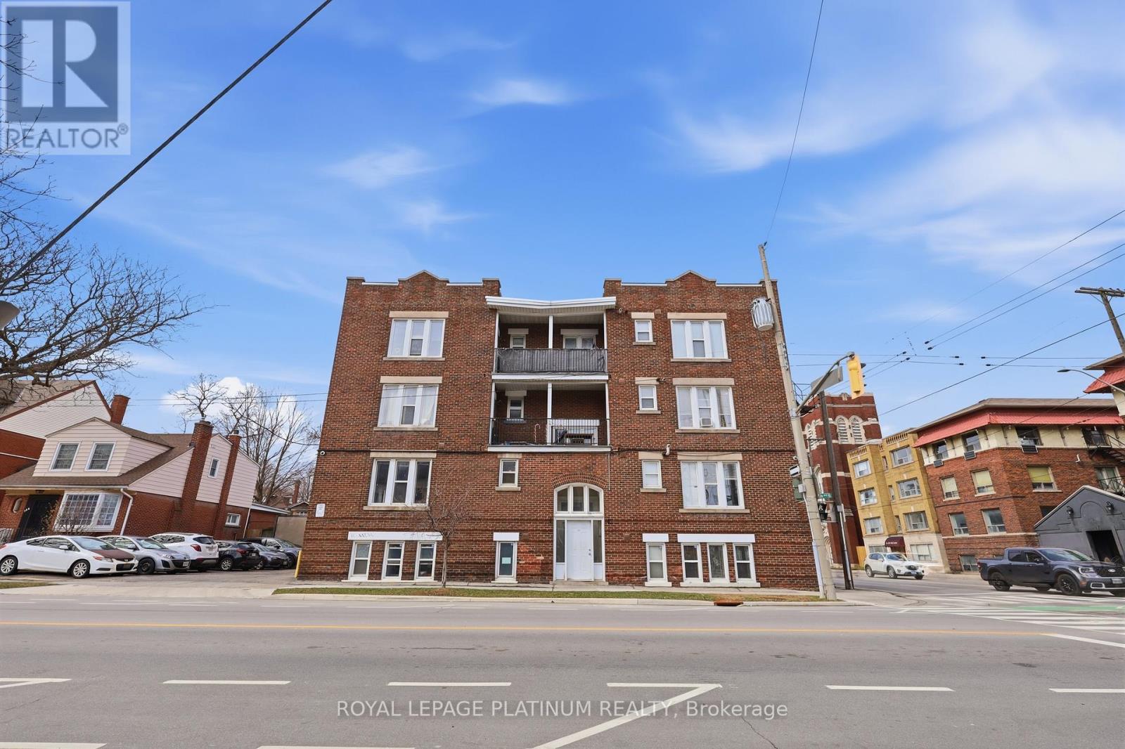 A building with the sign "Royal LePage Platinum Realty Brokerage" in front of it.