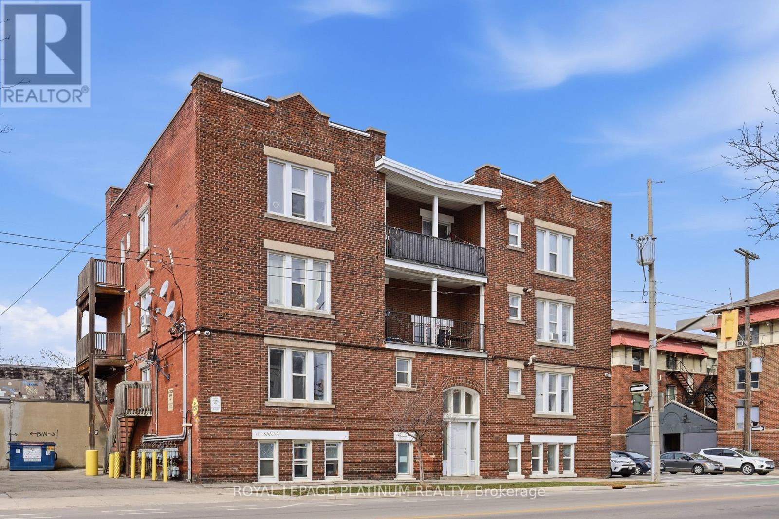 A red brick building with a balcony on the second floor.
