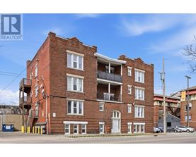 A red brick building with a balcony on the second floor.
