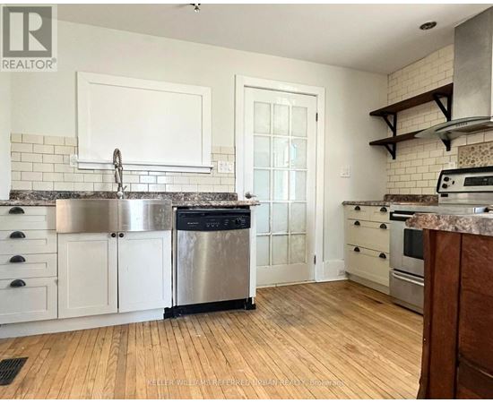 A kitchen with white cabinets and a stainless steel dishwasher.