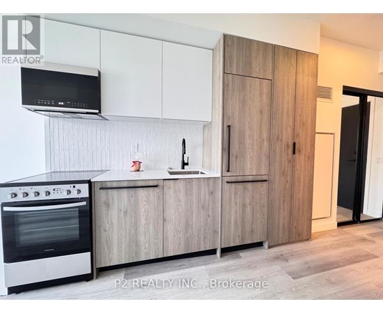 A modern kitchen with wooden cabinets and a stainless steel oven.