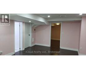 A room with pink walls and a wooden door.