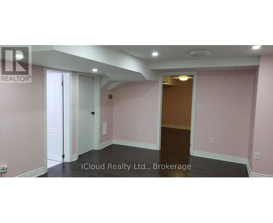 A room with pink walls and a wooden door.