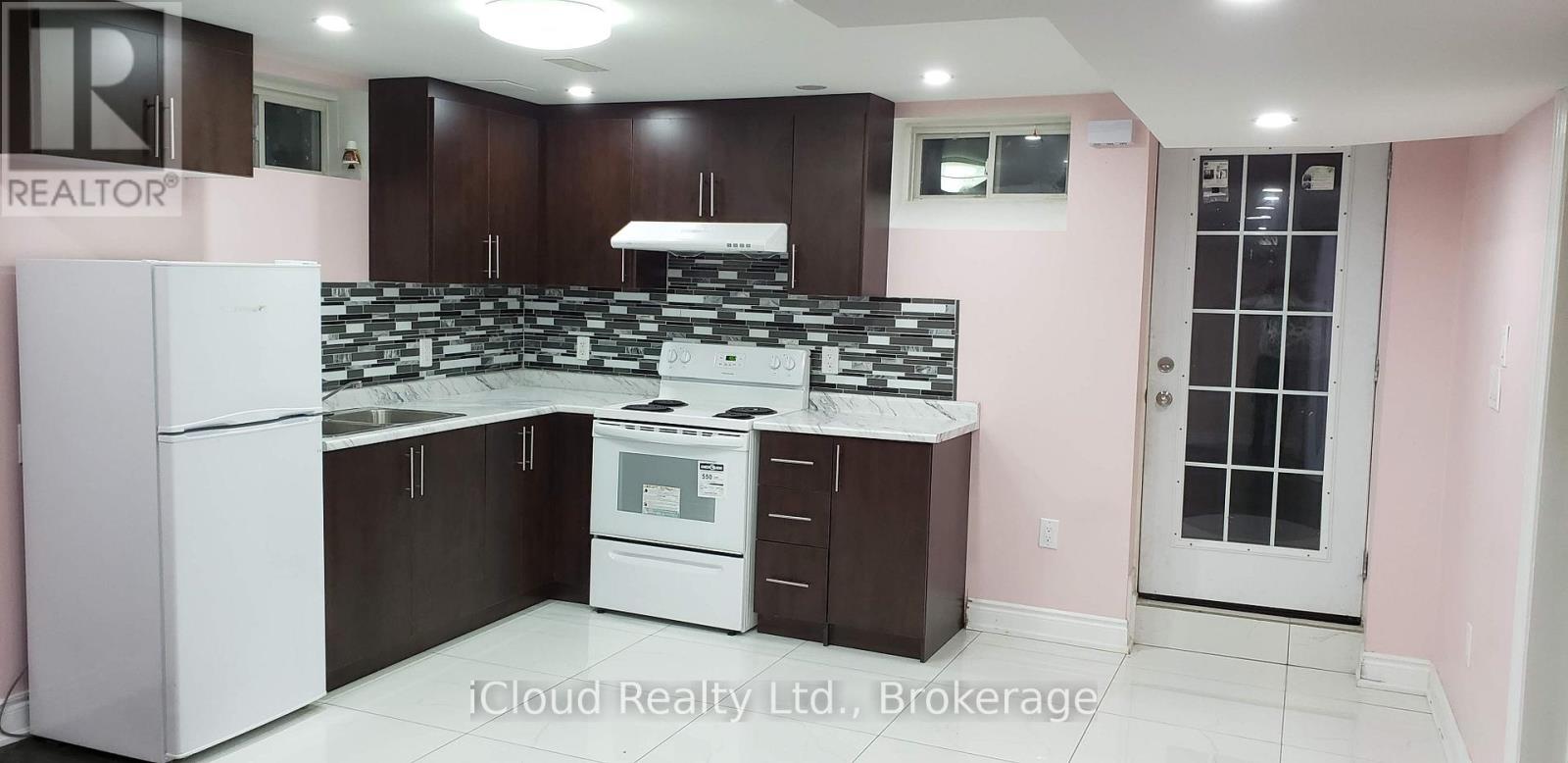 A kitchen with a white refrigerator and a white stove top oven.