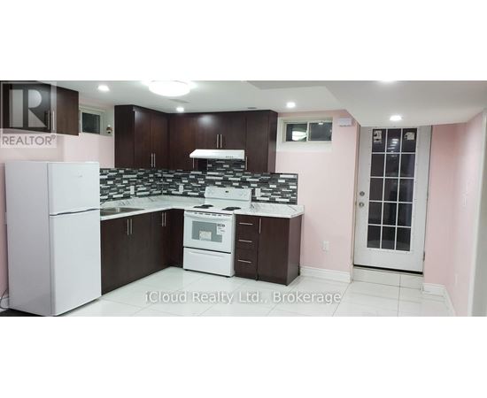 A kitchen with a white refrigerator and a white stove top oven.