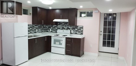 A kitchen with a white refrigerator and a white stove top oven.