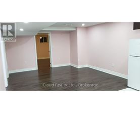 A room with pink walls and a wooden door.