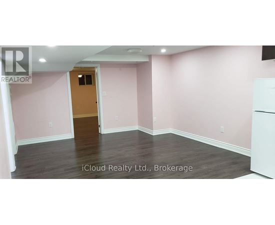 A room with pink walls and a wooden door.