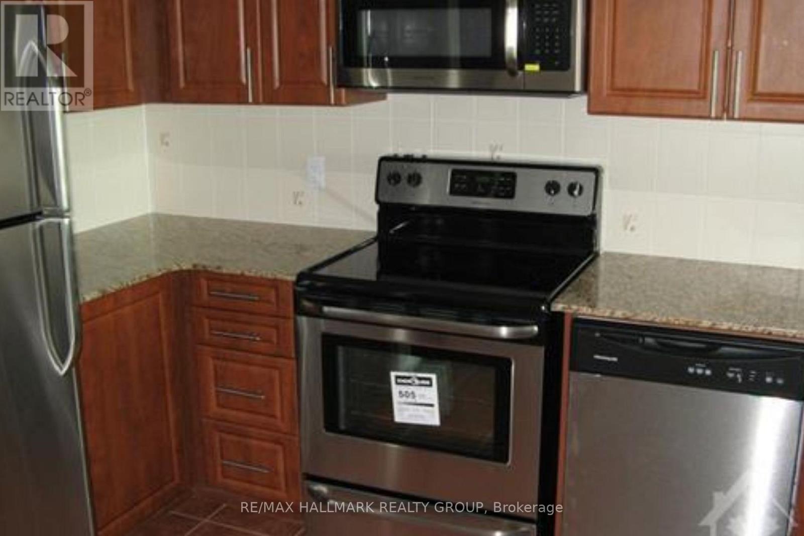 A kitchen with a stove top oven and microwave.