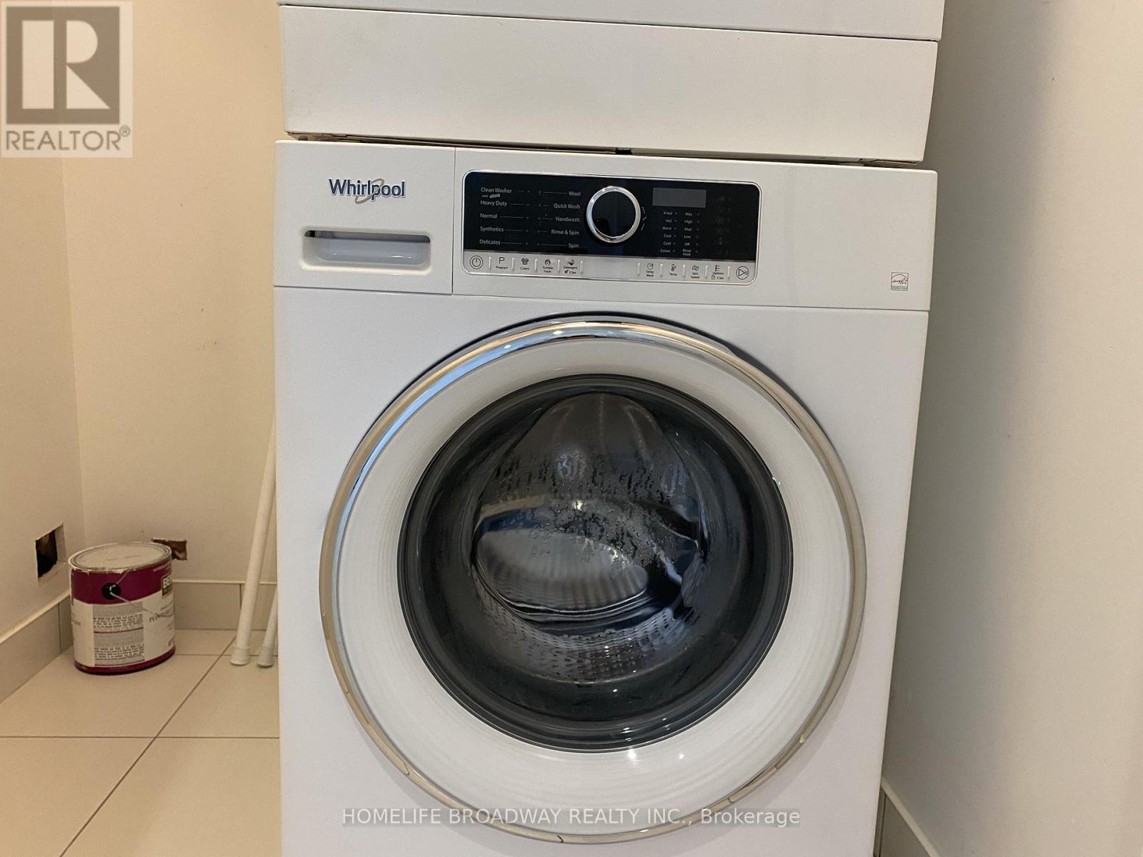A white Whirlpool washing machine in a laundry room.