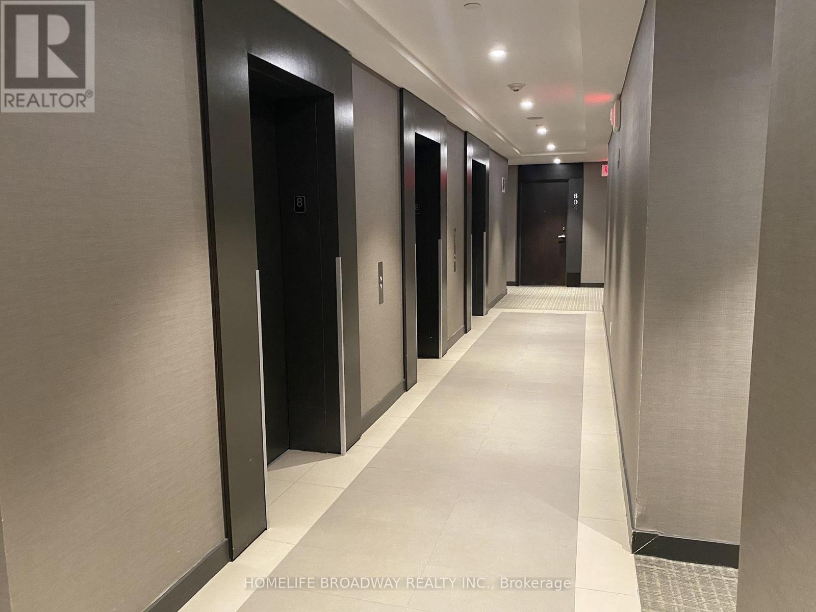 A long hallway with doors on both sides.
