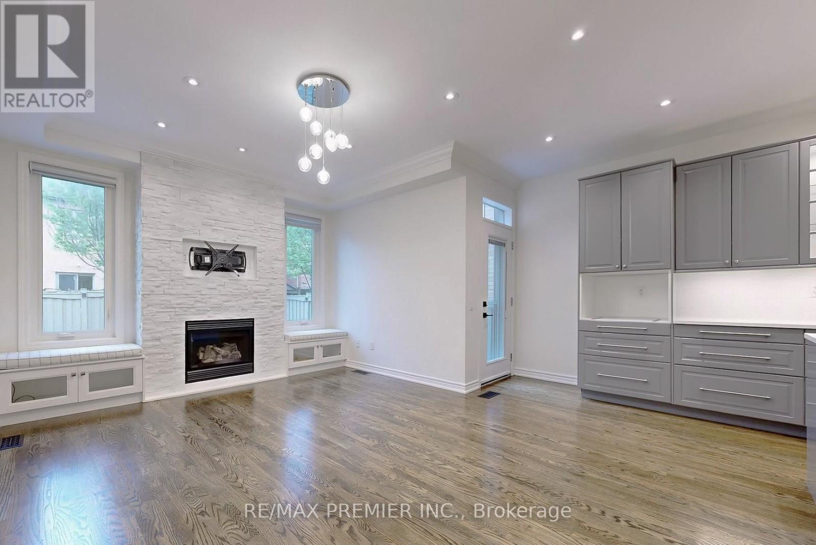A spacious living room with a fireplace and built-in cabinets.