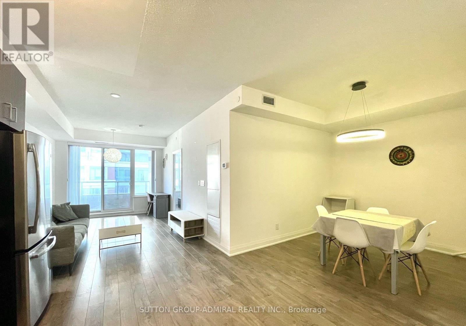 A spacious room with a dining table and chairs.