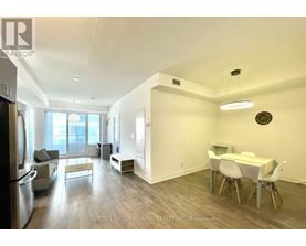 A spacious room with a dining table and chairs.
