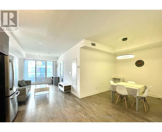 A spacious room with a dining table and chairs.
