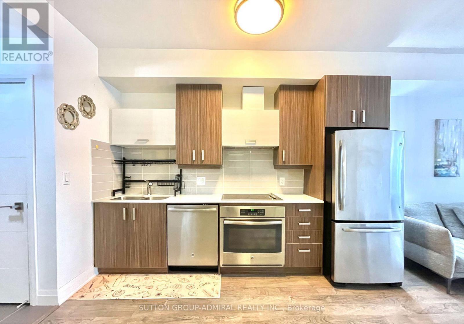 A kitchen with wooden cabinets and stainless steel appliances.