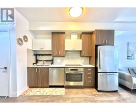 A kitchen with wooden cabinets and stainless steel appliances.