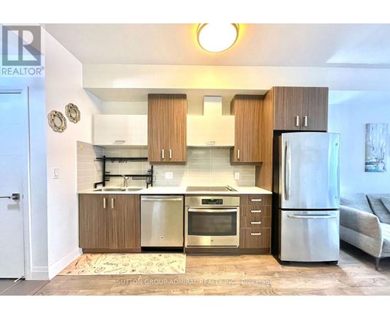 A kitchen with wooden cabinets and stainless steel appliances.