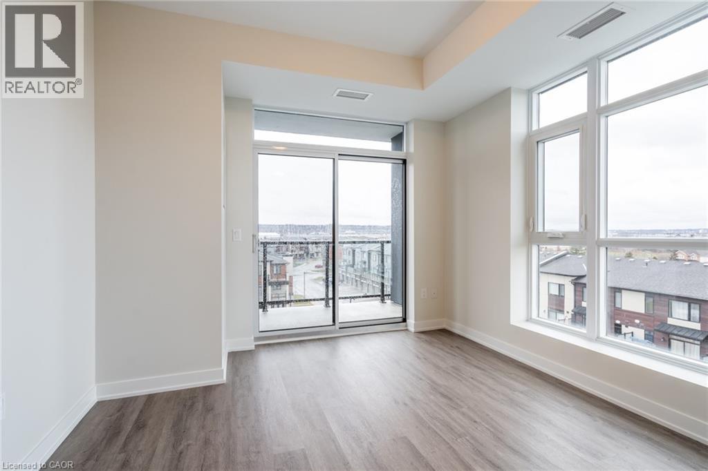 A spacious room with a view of the city through large windows.