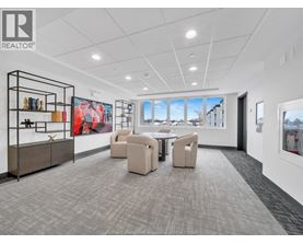 A spacious office room with a large table and chairs.