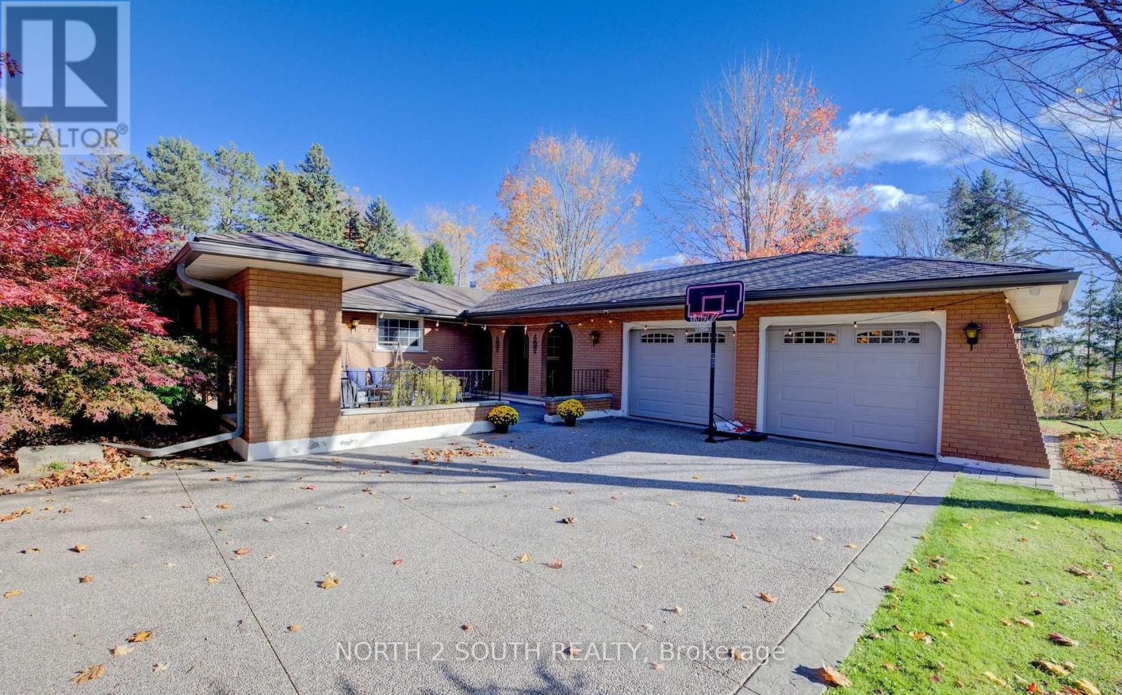 A house with a driveway and a garage is for sale.