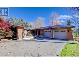 A house with a driveway and a garage is for sale.