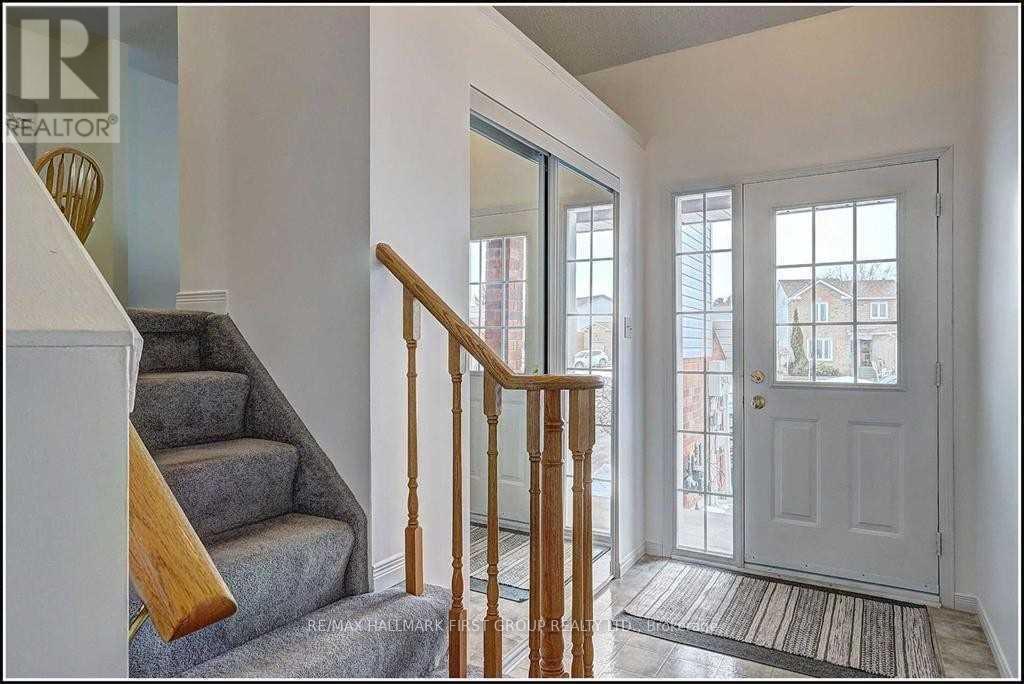 A hallway with a staircase leading to the second floor.