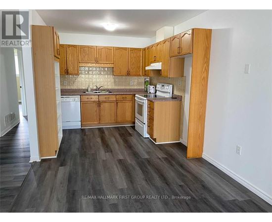 A kitchen with wooden cabinets and a white dishwasher.