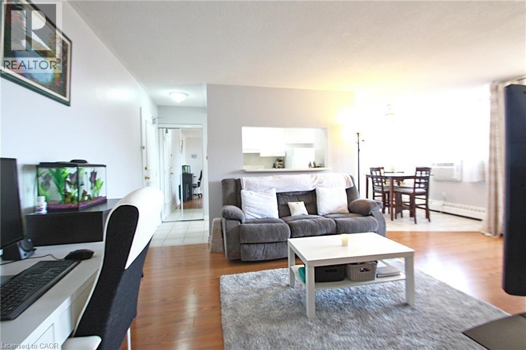 A living room with a grey couch and a white coffee table.