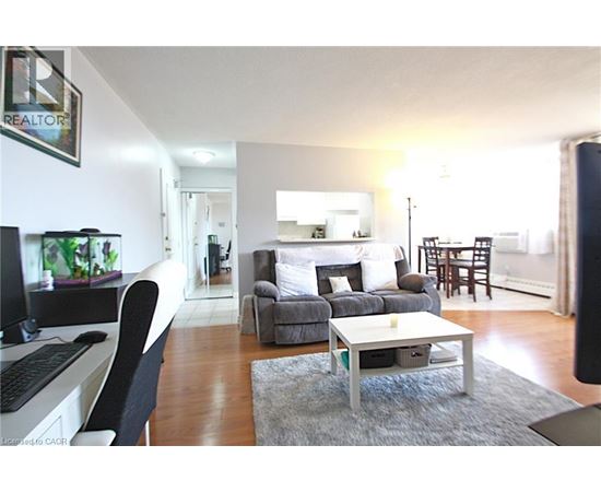 A living room with a grey couch and a white coffee table.